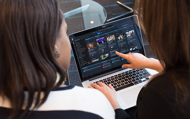 Two women are looking at a laptop screen